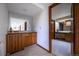 Wet bar features wood cabinets, sink, refrigerator and a view into another bathroom area at 10353 N Chatfield Dr, Littleton, CO 80125