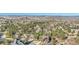 Expansive aerial view of a residential neighborhood nestled among trees, showcasing a community surrounded by mountains at 2091 Ramblewood Ct, Castle Rock, CO 80104