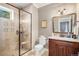 Bathroom with tiled glass shower and wood vanity at 2091 Ramblewood Ct, Castle Rock, CO 80104