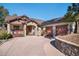 Inviting home with a stone and wood facade, paired garage doors, and manicured landscaping for great curb appeal at 2091 Ramblewood Ct, Castle Rock, CO 80104