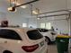 Inside a well lit two car garage showing one car parked and open garage doors at 2091 Ramblewood Ct, Castle Rock, CO 80104