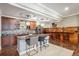 Basement kitchen with center island, custom cabinets, bar seating and stylish pendant lights at 2091 Ramblewood Ct, Castle Rock, CO 80104