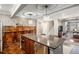 Gourmet kitchen with island and bar, stainless appliances, and wood paneled walls at 2091 Ramblewood Ct, Castle Rock, CO 80104