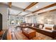 Bright living room showcasing exposed beams, a leather sectional, and a stylish coffee table at 2091 Ramblewood Ct, Castle Rock, CO 80104
