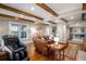 Relaxing living room showcasing exposed beams, a leather sectional, and hardwood floors at 2091 Ramblewood Ct, Castle Rock, CO 80104