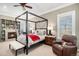 Spacious main bedroom featuring a canopy bed, fireplace, and built-in shelving at 2091 Ramblewood Ct, Castle Rock, CO 80104