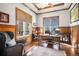 Home office with custom wood paneling, built in desk, and an abundance of natural light at 2091 Ramblewood Ct, Castle Rock, CO 80104