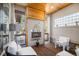 Outdoor patio with a stone fireplace, comfortable seating, and an abundance of natural light at 2091 Ramblewood Ct, Castle Rock, CO 80104