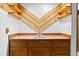 Basement wet bar with wooden accents and decorative wall feature at 2306 S Troy St # A, Aurora, CO 80014