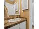 Bathroom vanity features a stone tile countertop, white cabinets, and ample storage at 2306 S Troy St # A, Aurora, CO 80014