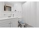 Bright bathroom features white vanity, toilet, mirror, and shower curtain at 2306 S Troy St # A, Aurora, CO 80014