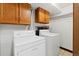 Functional laundry room with washer, dryer, storage cabinets and tile floor at 2306 S Troy St # A, Aurora, CO 80014