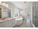 Bright bathroom features dual sinks, a soaking tub, a separate shower, and lots of natural light at 13900 Hanging Lake St, Parker, CO 80138