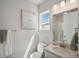 Bright bathroom with a marble countertop sink, natural lighting, a flower painting, and a white towel at 13900 Hanging Lake St, Parker, CO 80138