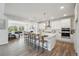 Open concept white kitchen with a large island, stainless steel appliances, and an open floor plan at 13900 Hanging Lake St, Parker, CO 80138