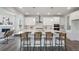 Modern kitchen island with pendant lighting, seating, and stainless steel appliances at 13900 Hanging Lake St, Parker, CO 80138