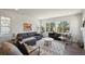 Bright living room with large windows, hardwood floors, a comfortable gray sofa, and stylish decor at 13900 Hanging Lake St, Parker, CO 80138