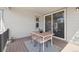 Outdoor patio with a dining table for four with a sliding glass door in the background at 13900 Hanging Lake St, Parker, CO 80138