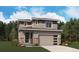 Charming two-story home with stone accents, two car garage, and a manicured front yard at 11157 Mount Emma Dr, Englewood, CO 80112