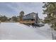 Modern two-story home with dark exterior siding and wooden deck at 7250 N Hyperion Way, Parker, CO 80134