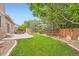 The backyard features well-manicured lawn, patio with seating, landscaping, and a privacy fence at 15056 Fillmore Way, Thornton, CO 80602