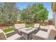 Inviting backyard patio features comfortable seating and a fire pit, perfect for outdoor gatherings and relaxation at 15056 Fillmore Way, Thornton, CO 80602