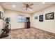 Finished basement features an arcade game, exercise equipment, tile floor and sports themed decorations at 15056 Fillmore Way, Thornton, CO 80602