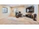 A finished basement area with a desk, media center, and carpet flooring provides flexible space at 15056 Fillmore Way, Thornton, CO 80602