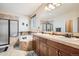 Bathroom featuring separate shower and soaking tub and dual sinks with natural lighting at 15056 Fillmore Way, Thornton, CO 80602