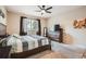 Spacious bedroom with a ceiling fan, a large window, and neutral carpet flooring at 15056 Fillmore Way, Thornton, CO 80602