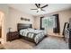 Bright bedroom features a comfortable bed, ceiling fan, and natural light from the large window at 15056 Fillmore Way, Thornton, CO 80602