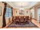 Elegant dining room with a coffered ceiling, hardwood floors, and stylish decor at 15056 Fillmore Way, Thornton, CO 80602