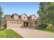 Beautiful home with a three-car garage, stone accents, and a well-manicured lawn at 15056 Fillmore Way, Thornton, CO 80602