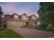 Lovely home with a three-car garage, stone accents, and a beautifully landscaped lawn at 15056 Fillmore Way, Thornton, CO 80602