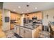 Modern kitchen with stainless steel appliances, a central island, and ample cabinet space at 15056 Fillmore Way, Thornton, CO 80602