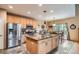 Spacious kitchen with stainless steel appliances, granite countertops, and a large island at 15056 Fillmore Way, Thornton, CO 80602