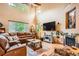 Bright living room with a fireplace, hardwood floors, and large windows providing ample light at 15056 Fillmore Way, Thornton, CO 80602