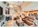 Open-concept living room with high ceilings, a fireplace, and hardwood floors at 15056 Fillmore Way, Thornton, CO 80602