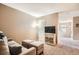 Cozy living room featuring a sofa, ottomans and a mounted television at 15056 Fillmore Way, Thornton, CO 80602