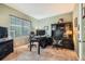 Well-lit office space with a large desk, comfortable chairs, and ample storage at 15056 Fillmore Way, Thornton, CO 80602