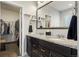 Double vanity bathroom with granite countertops and large mirror at 6845 W Evans Ave, Denver, CO 80227