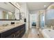 Elegant bathroom with granite double vanity, soaking tub, and shower at 6845 W Evans Ave, Denver, CO 80227