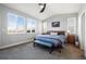 Spacious primary bedroom with carpeted floors and large windows at 6845 W Evans Ave, Denver, CO 80227