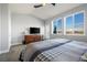 Bright bedroom with a large bed, dresser, and access to balcony at 6845 W Evans Ave, Denver, CO 80227