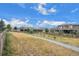 A gravel path winds through a grassy area, past homes at 6845 W Evans Ave, Denver, CO 80227