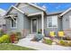 Inviting front entrance with stone accents and colorful landscaping at 6845 W Evans Ave, Denver, CO 80227