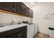 Laundry room with washer, dryer and storage at 6845 W Evans Ave, Denver, CO 80227