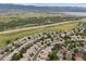 Aerial view showcasing the community and its scenic surroundings, including a lake and mountains at 3305 White Oak Ln, Highlands Ranch, CO 80129