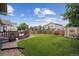 Expansive backyard with lush lawn, wooden deck, shed, and privacy fence at 3305 White Oak Ln, Highlands Ranch, CO 80129