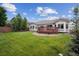 Spacious backyard with grass and wooden deck at 3305 White Oak Ln, Highlands Ranch, CO 80129